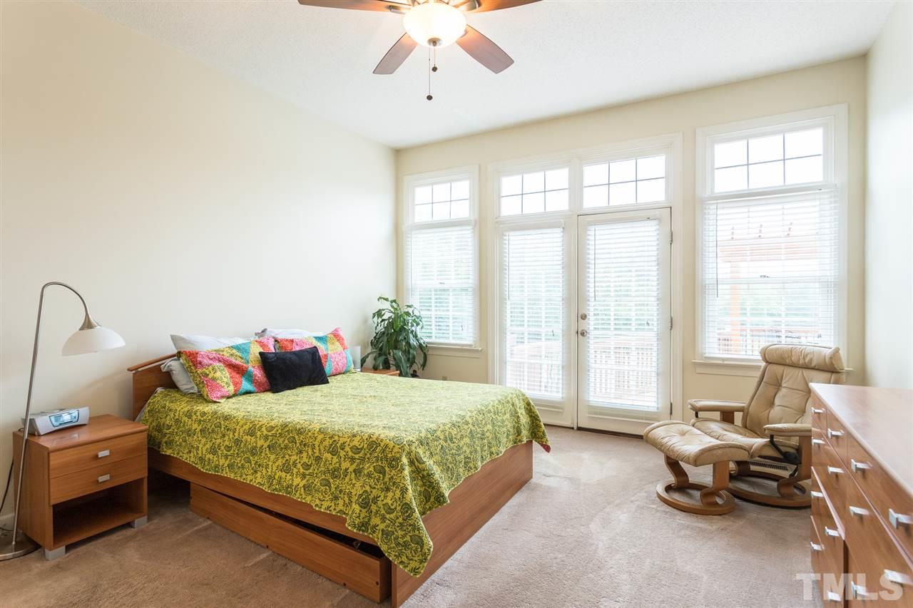 10121 Goodview Court Raleigh, NC 27613 - Photo 21 of 30 a bedroom with a bed and a couch