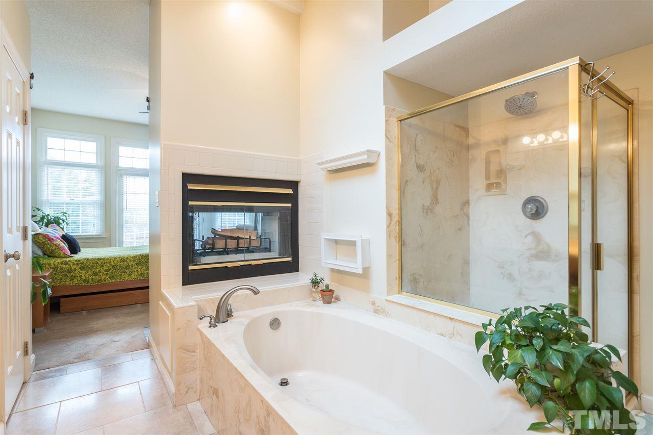 10121 Goodview Court Raleigh, NC 27613 - Photo 24 of 30 a bathroom with a tub and a shower