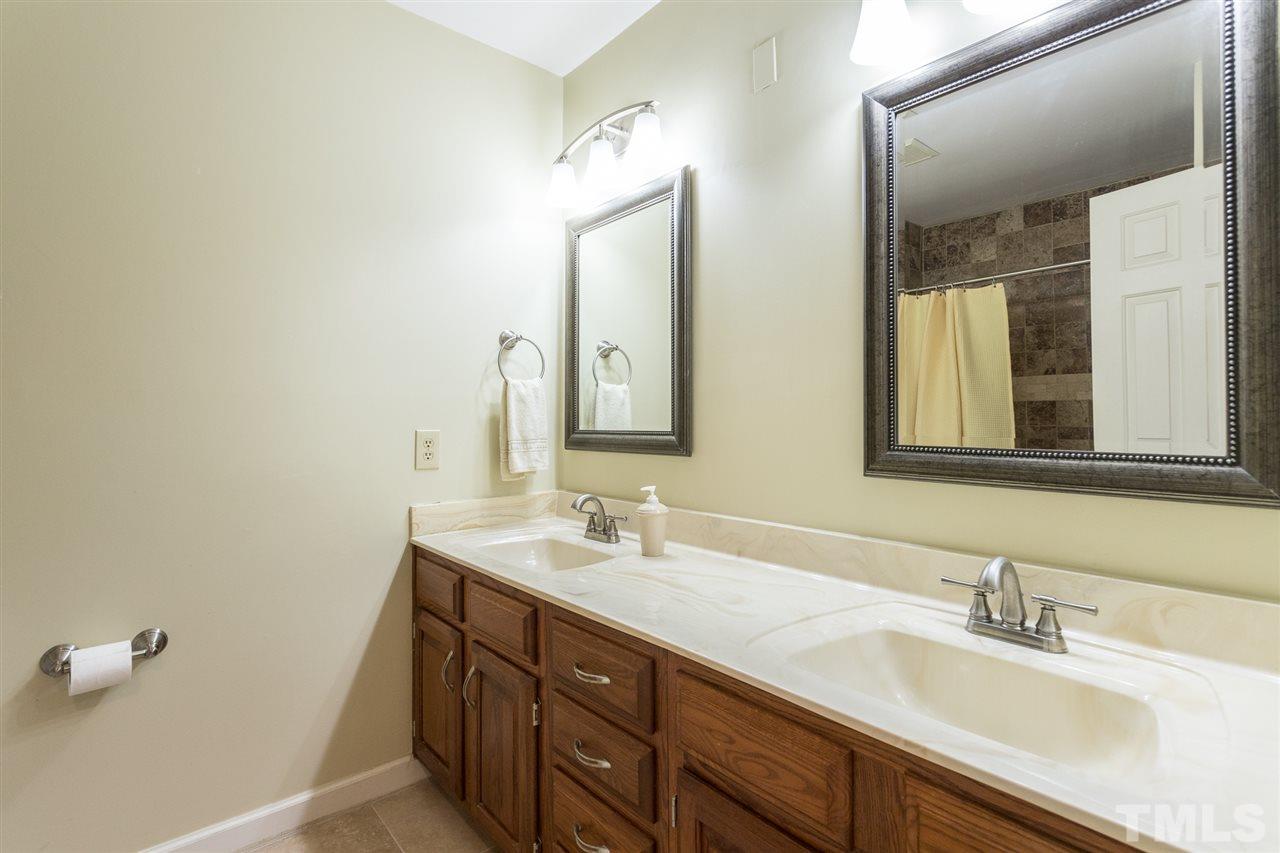 10121 Goodview Court Raleigh, NC 27613 - Photo 28 of 30 a bathroom with a sink and a mirror