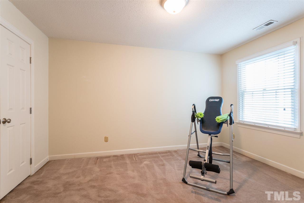 10121 Goodview Court Raleigh, NC 27613 - Photo 29 of 30 a room with gym equipment and a window
