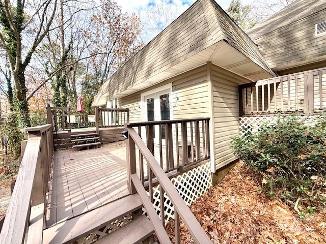 a view of a house with wooden deck