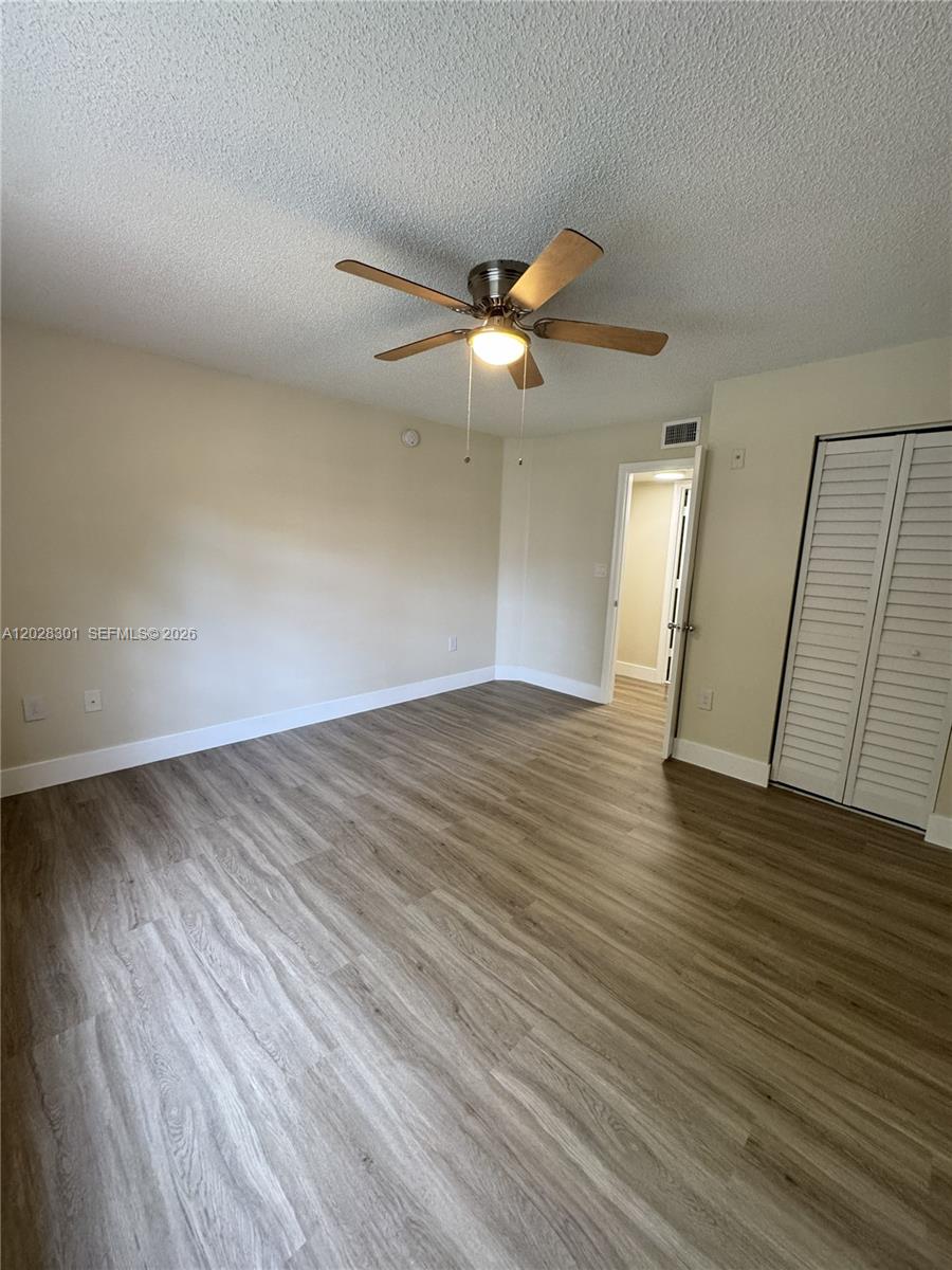 2021 Renaissance Boulevard, Unit 201 Miramar, FL 33025 - Photo 12 of 26 wooden floor in an empty room with a window