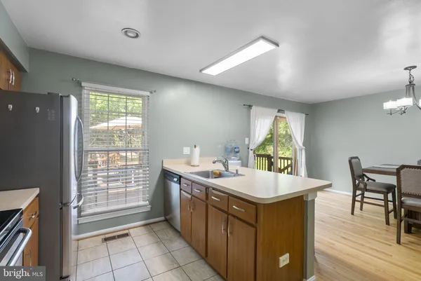 a kitchen with a stove a sink and a refrigerator