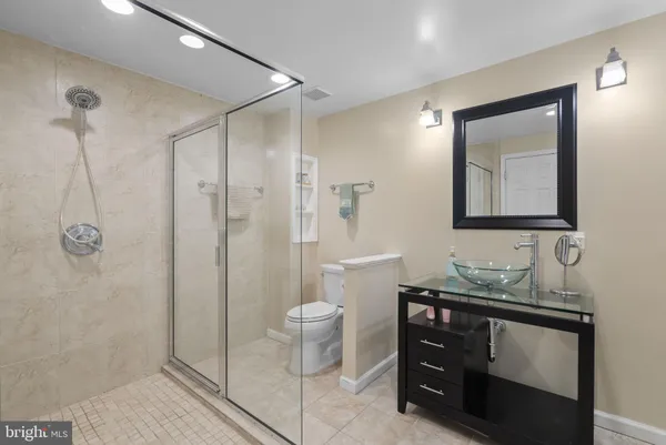 a bathroom with a toilet sink and shower