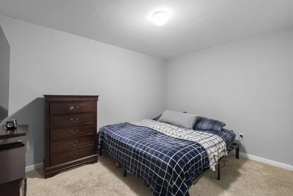 a bedroom with a bed and a dresser