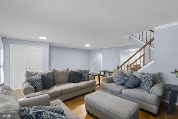 a living room with furniture and stairs