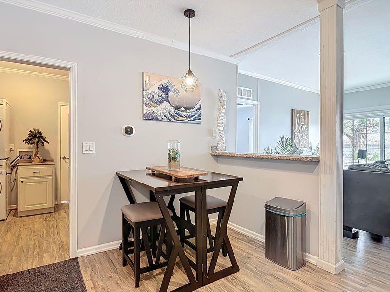 102 Ash Street Edgewater, FL 32141 - Photo 11 of 36 a view of a dining room with furniture and wooden floor