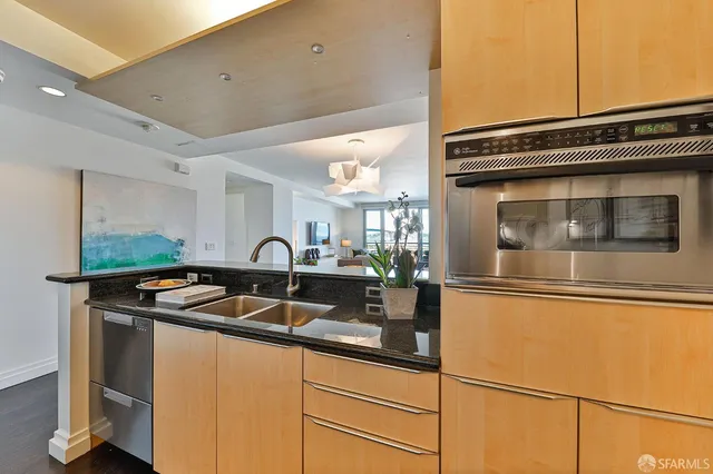 a spacious bedroom with a bed a couch and large window