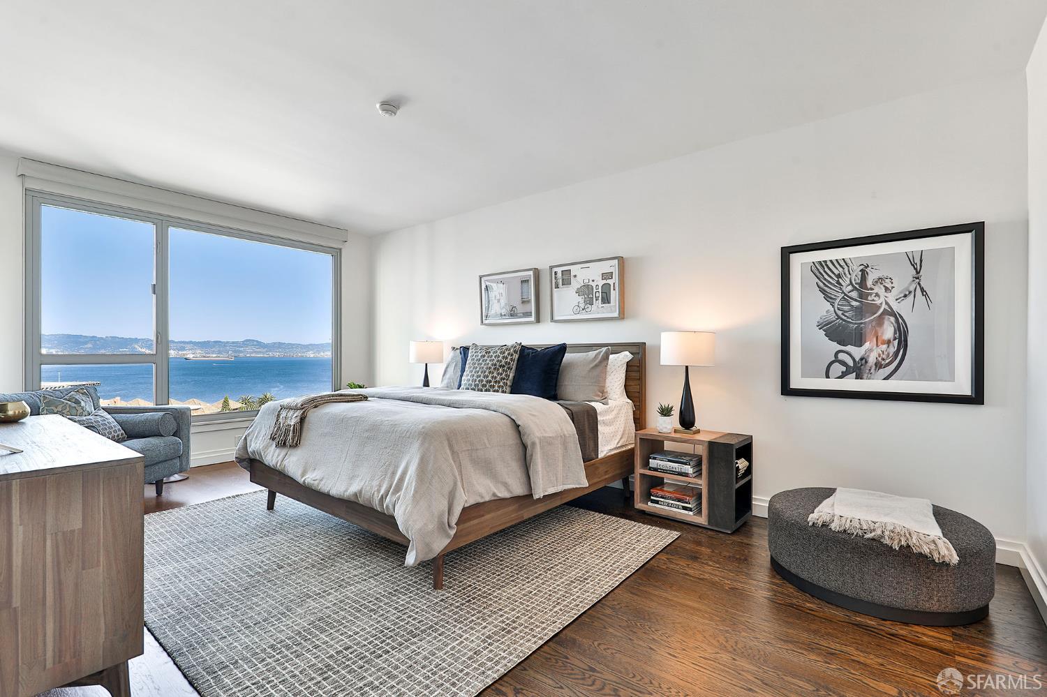 229 Brannan Street, Unit 12C San Francisco, CA 94107 - Photo 20 of 57 a spacious bedroom with a bed a couch and large window