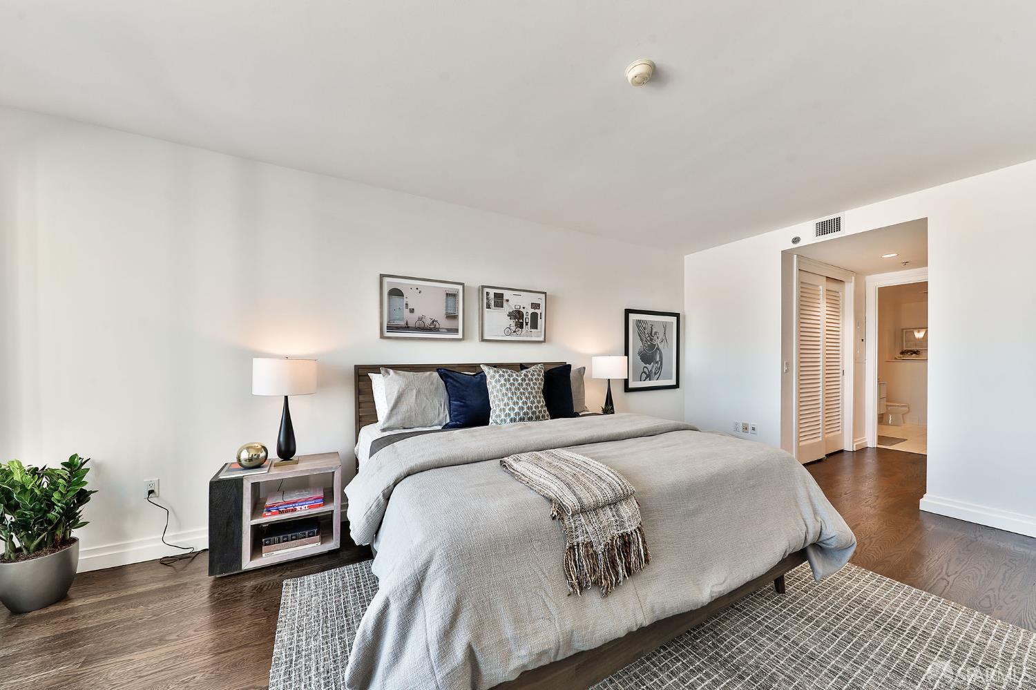 229 Brannan Street, Unit 12C San Francisco, CA 94107 - Photo 23 of 57 a bedroom with a bed and wooden floor