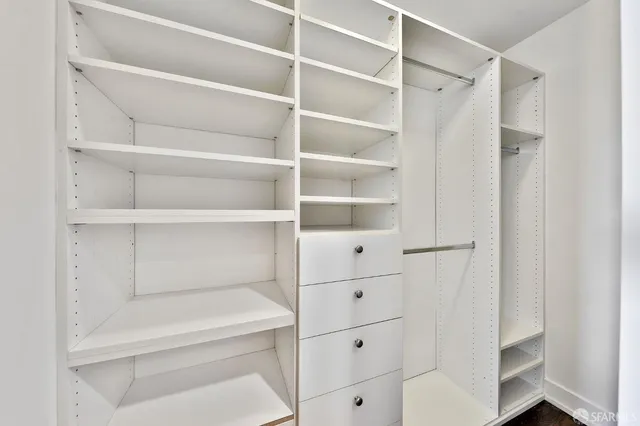 a bathroom with a granite countertop sink mirror and toilet