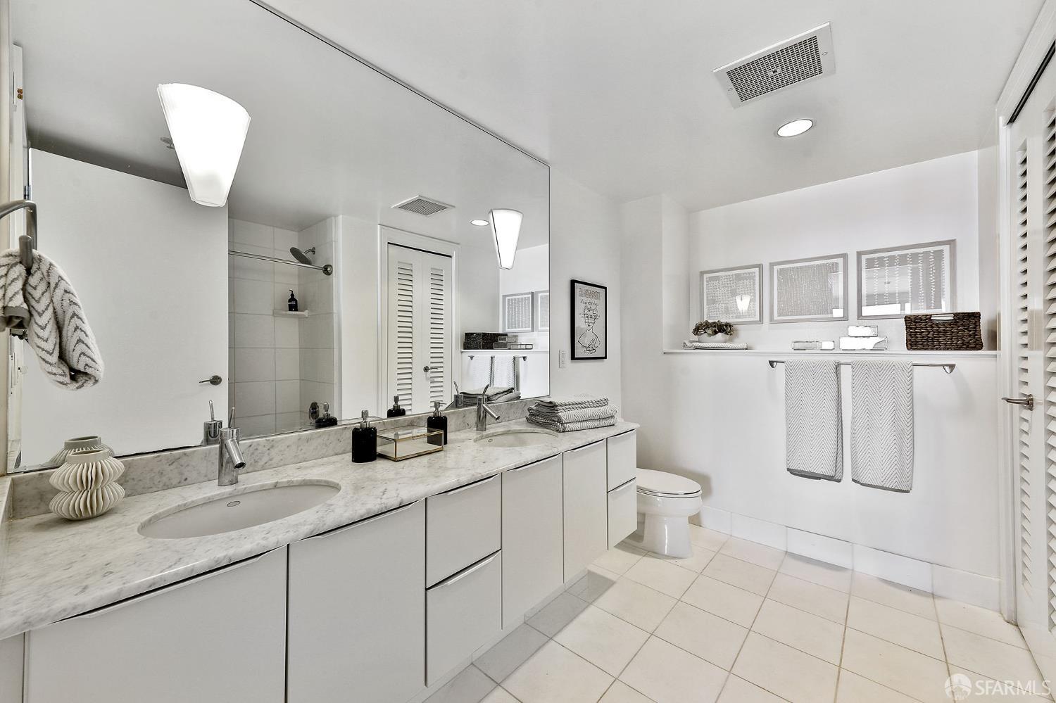 229 Brannan Street, Unit 12C San Francisco, CA 94107 - Photo 27 of 57 a bathroom with a granite countertop sink mirror and toilet