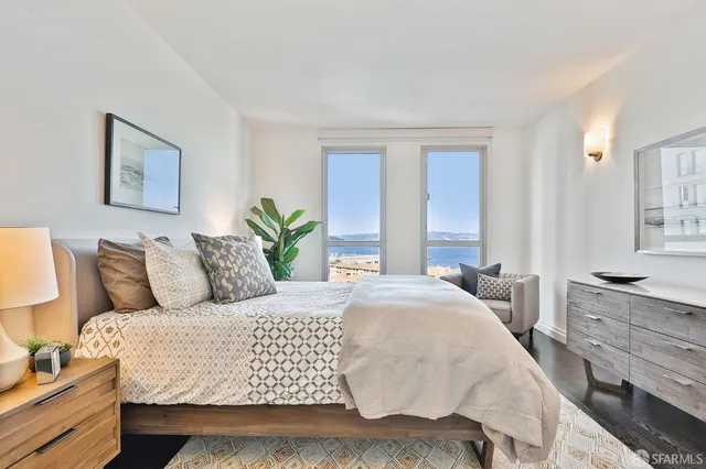 a bedroom with a large bed and a large window