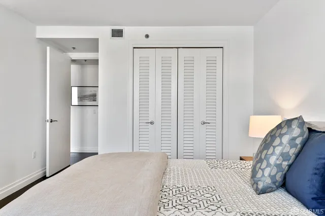 a bedroom with a bed and a mirror