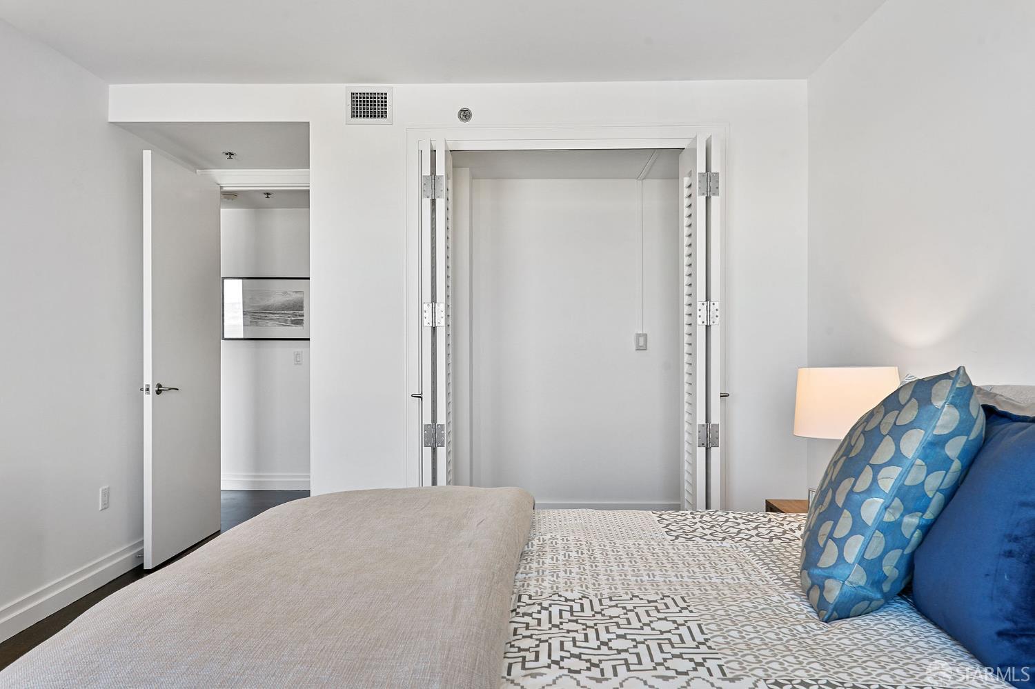 229 Brannan Street, Unit 12C San Francisco, CA 94107 - Photo 34 of 57 a bedroom with a bed and a mirror