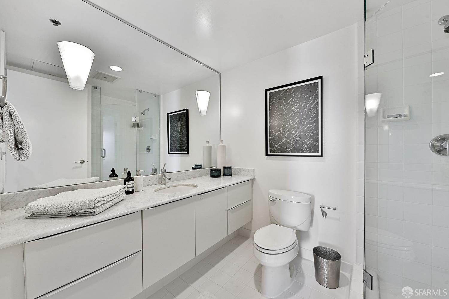 229 Brannan Street, Unit 12C San Francisco, CA 94107 - Photo 35 of 57 a bathroom with a toilet sink and mirror
