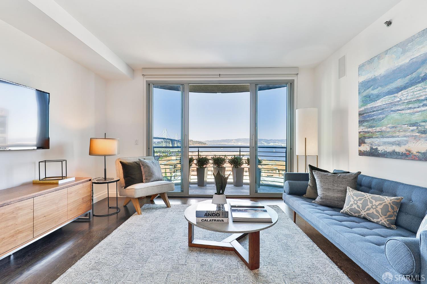 229 Brannan Street, Unit 12C San Francisco, CA 94107 - Photo 5 of 57 a living room with furniture and a lamp