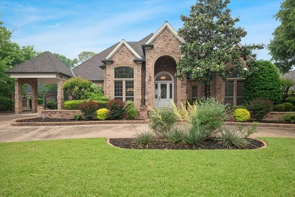 a front view of a house with garden
