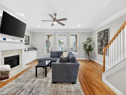 a living room with furniture and a wooden floor