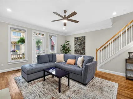 a living room with furniture a flat screen tv and a fireplace