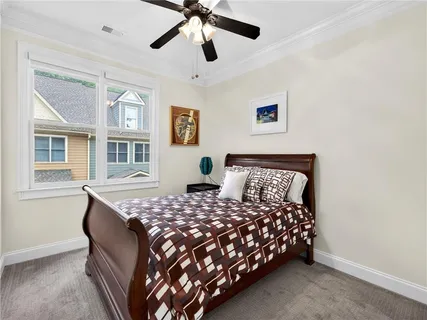 a bedroom with a large bed and a flat tv screen