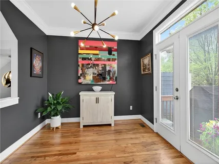 a kitchen with stainless steel appliances granite countertop a refrigerator a sink dishwasher a stove and white countertops with wooden floor