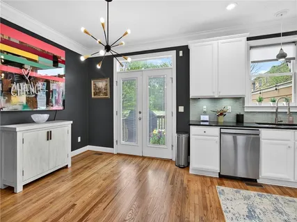 a kitchen with stainless steel appliances granite countertop a refrigerator sink and stove
