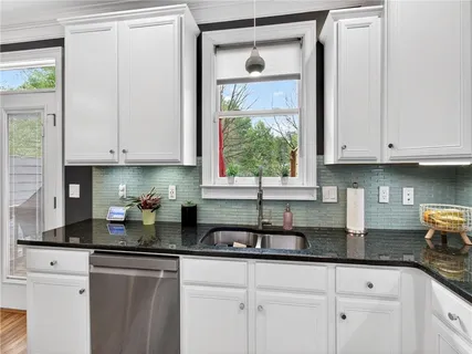 a kitchen with a refrigerator and cabinets