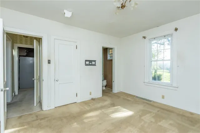 a view of a room with wooden floor