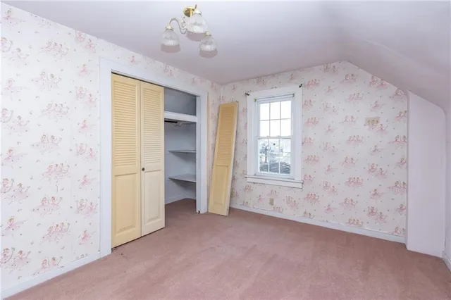 a view of an empty room with a fireplace