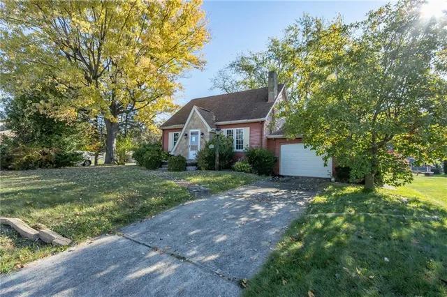 a view of a house with yard and a garden