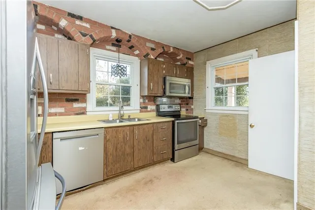 a kitchen with a refrigerator a sink and cabinets
