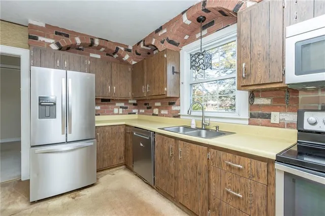an empty room with chandelier fan and closet