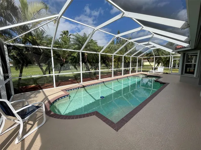 a view of a backyard with a swimming pool