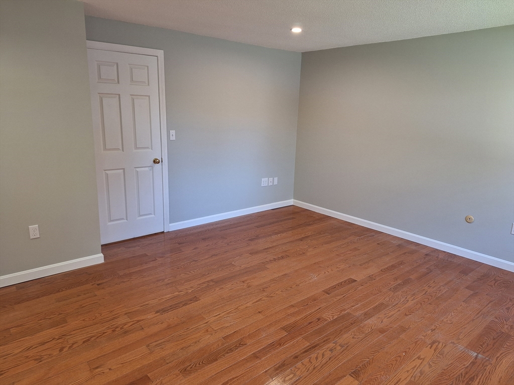 4 Beal's Cove Road, Unit F Hingham, MA 02043 - Photo 4 of 22 a view of an empty room with wooden floor