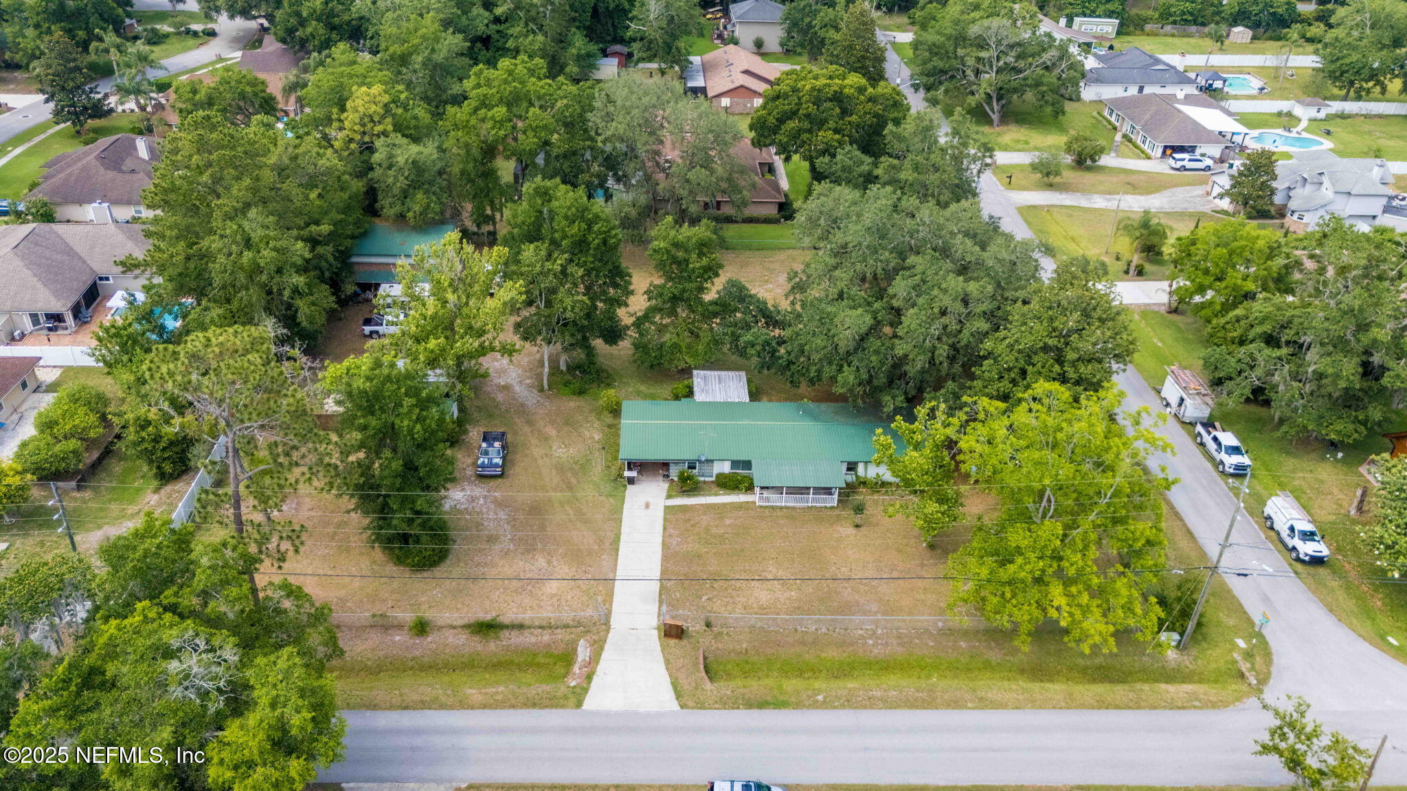 an aerial view of residential houses with outdoor space