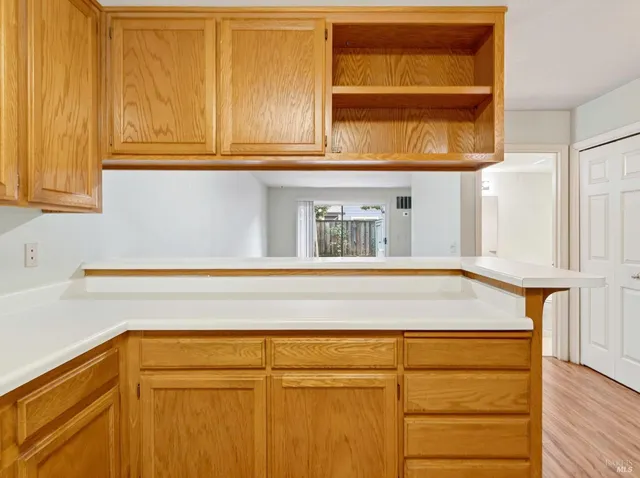 a kitchen with granite countertop cabinets stainless steel appliances a sink and wooden floor