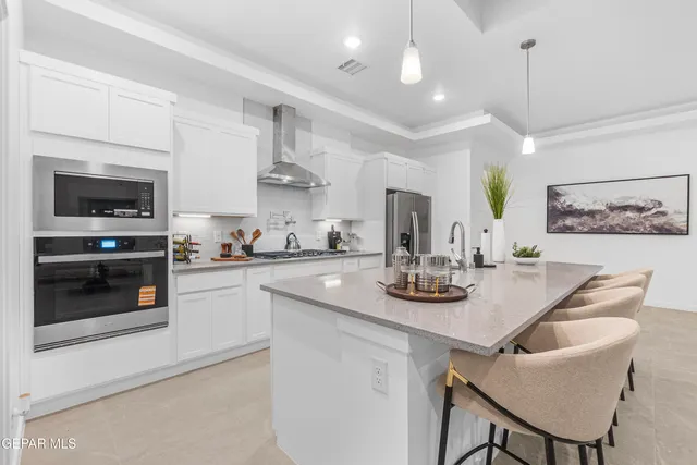 a kitchen with stainless steel appliances kitchen island granite countertop a sink and cabinets