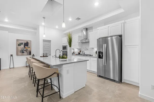 a living room with furniture and view of kitchen