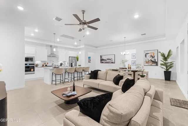 a view of a dining room with furniture and a chandelier