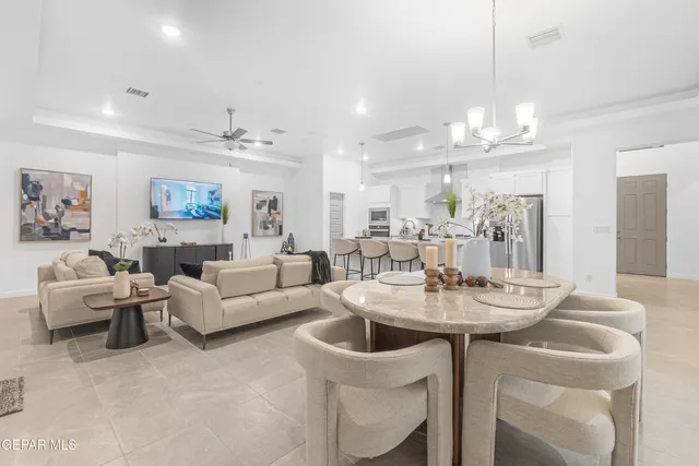 a living room with furniture and kitchen view