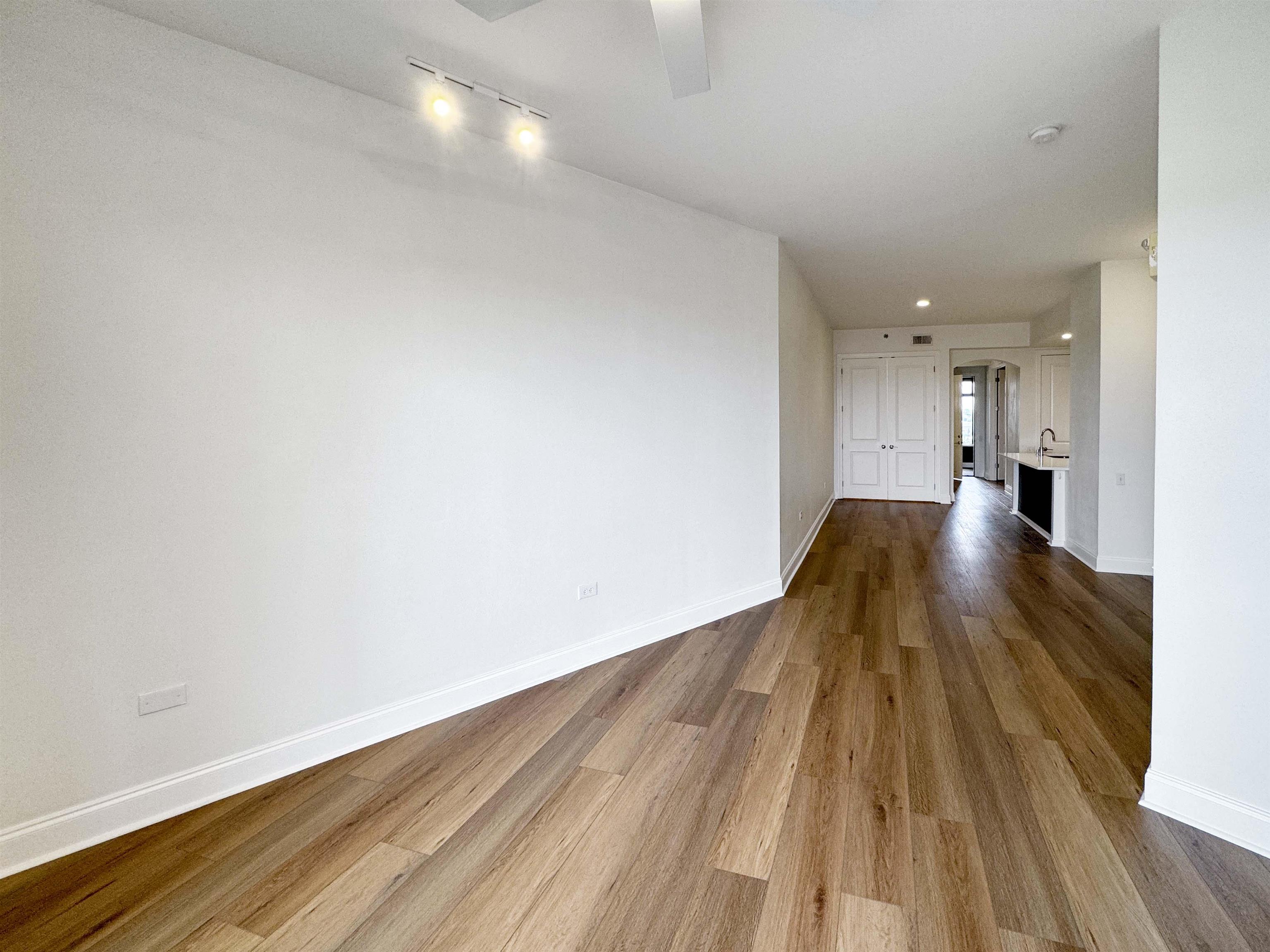717 Riverside Drive, Unit 707 Memphis, TN 38103 - Photo 11 of 39 Spare room with track lighting and hardwood / wood-style flooring