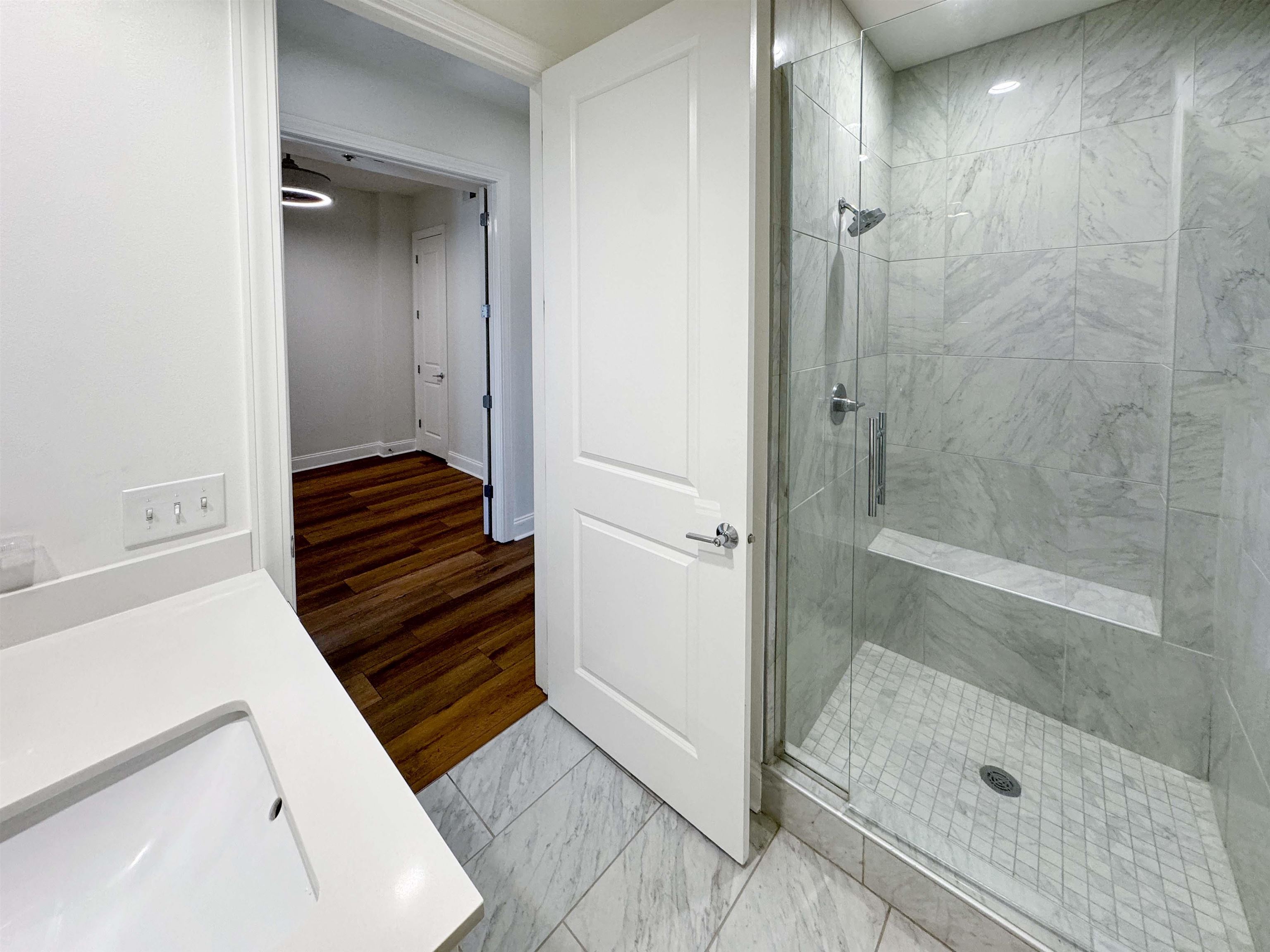 717 Riverside Drive, Unit 707 Memphis, TN 38103 - Photo 20 of 39 Bathroom featuring an enclosed shower, vanity, and hardwood / wood-style floors