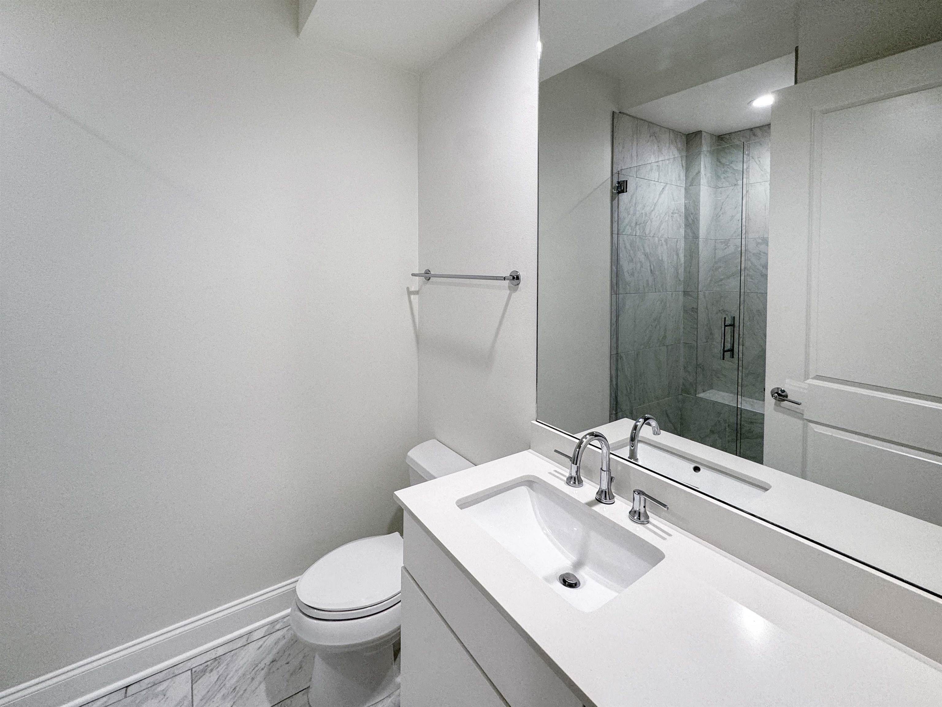 717 Riverside Drive, Unit 707 Memphis, TN 38103 - Photo 21 of 39 Bathroom featuring tile flooring, vanity with extensive cabinet space, a shower with shower door, and toilet