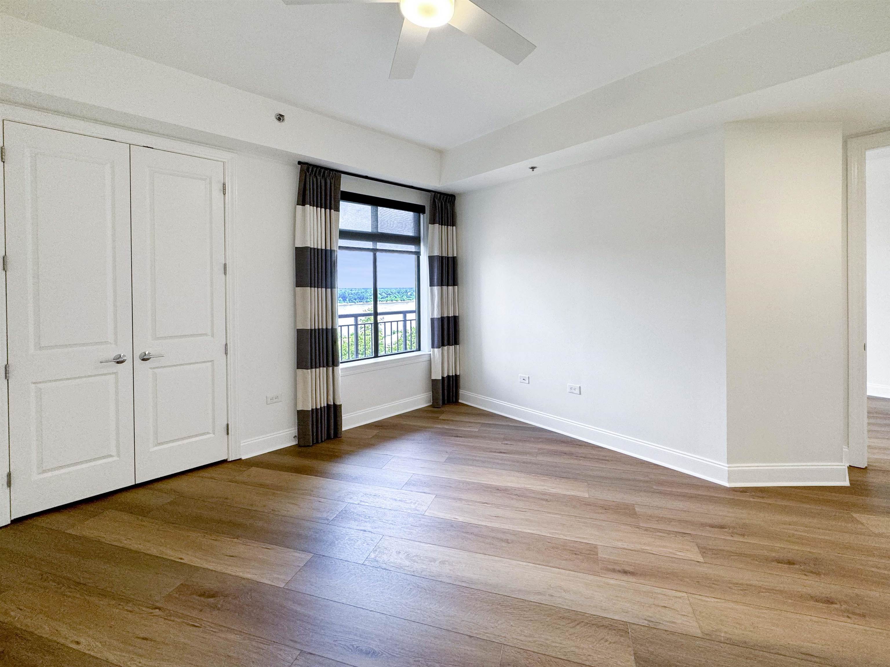 717 Riverside Drive, Unit 707 Memphis, TN 38103 - Photo 24 of 39 Unfurnished bedroom with wood-type flooring, a closet, and ceiling fan