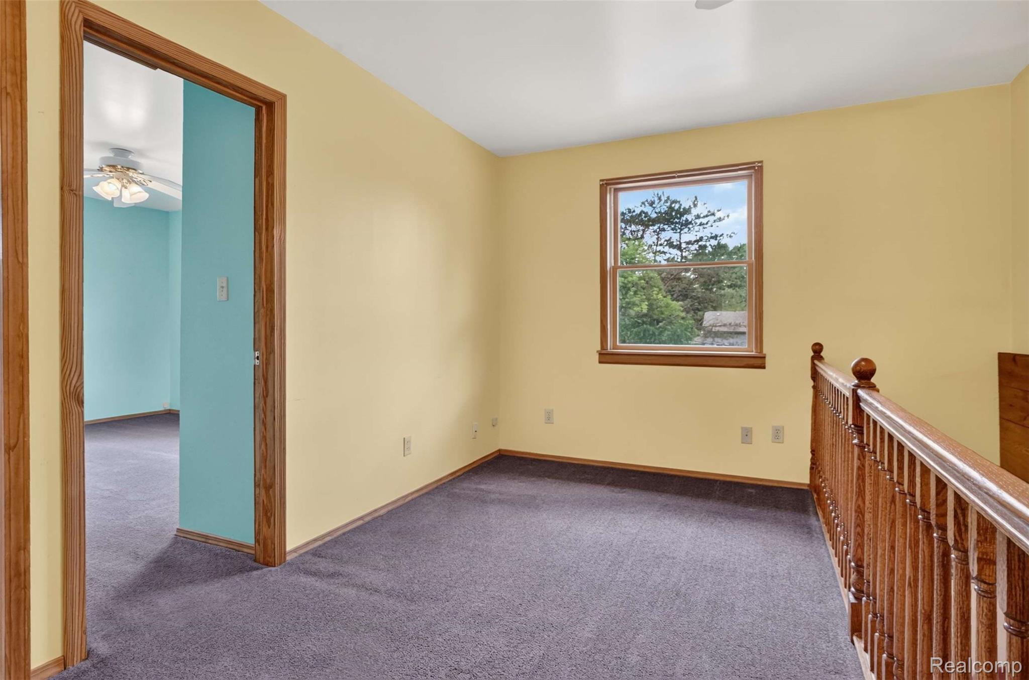 1437 East Cook Road Grand Blanc, MI 48439 - Photo 61 of 69 Upper-level space featuring light yellow walls and dark gray carpeting