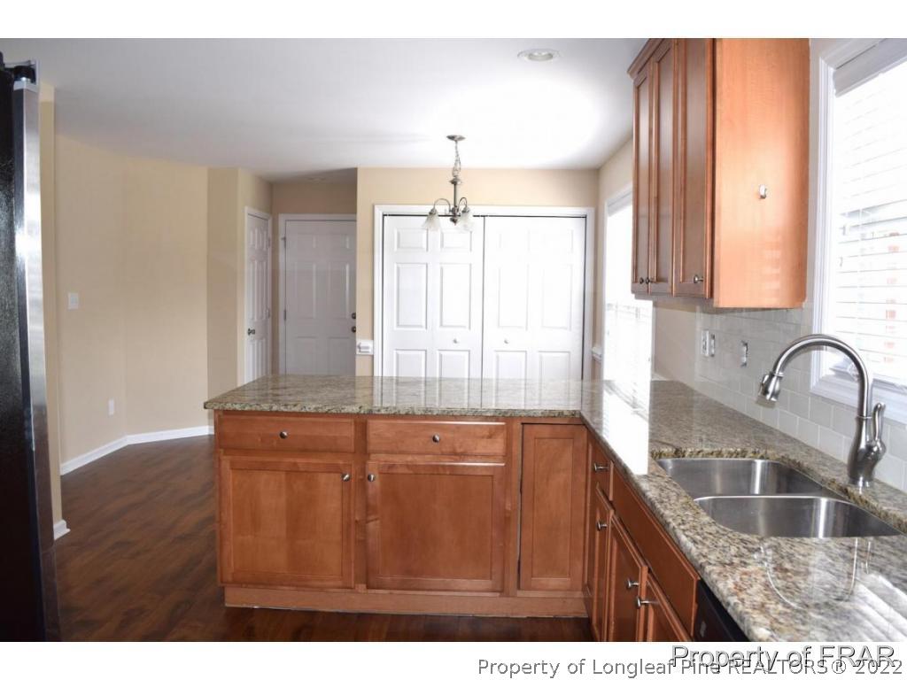 192 Lennox Loop Raeford, NC 28376 - Photo 15 of 33 a kitchen with a sink a window and cabinets