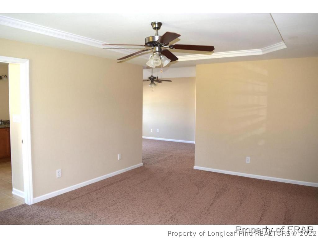 192 Lennox Loop Raeford, NC 28376 - Photo 25 of 33 a view of a hallway with a chandelier fan and wooden floor