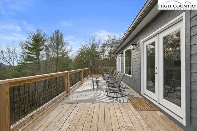 a view of balcony with two chairs and wooden floor