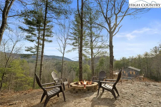a outdoor view with a sitting space and trees